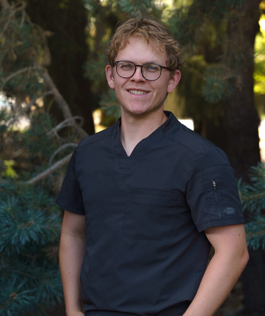 An image of Dr. Tyler Furgason, a male chiropractor, wearing glasses and smiling.